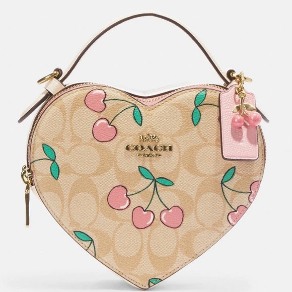 Coach Handbags - Coach Hearted shaped signature canvas Pink Cherry 🍒 ❤️ crossbody bag BN LE